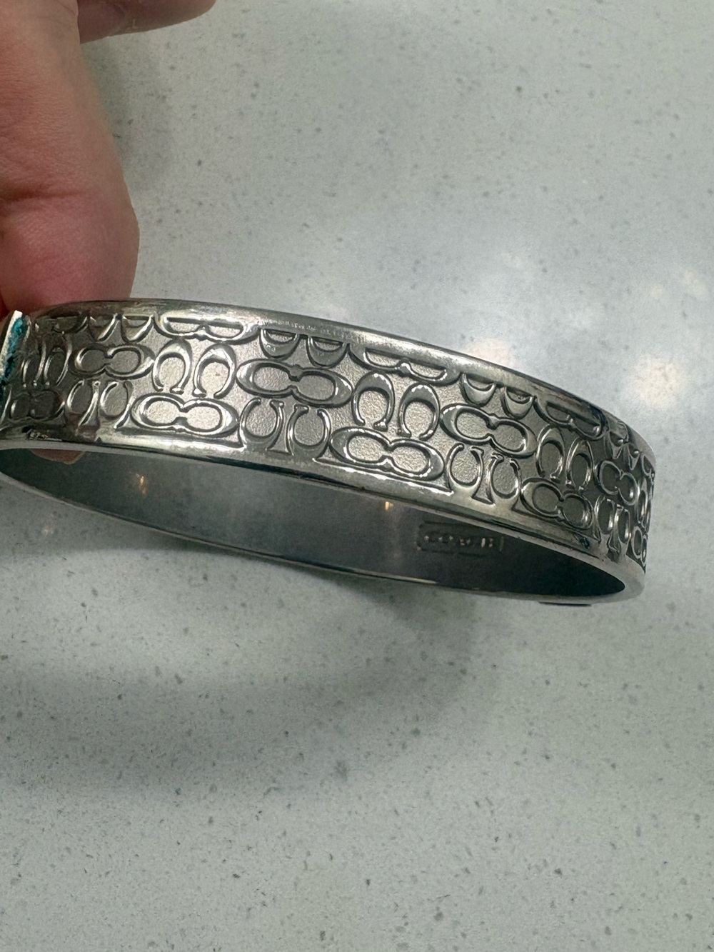 COACH Silver Tone Logo-Pattern Hinged Bangle Bracelet